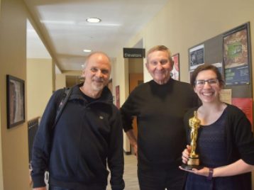 John Nelson poses with Professor Emeritus Frank Beaver and SAC senior Maddie Fyke outside of the SAC office